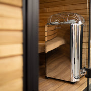 Harvia Club sauna heater viewed through a glass sauna door