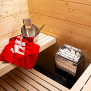 Harvia KIP60W electric sauna heater with metal casing and control knob, designed for home sauna heating.