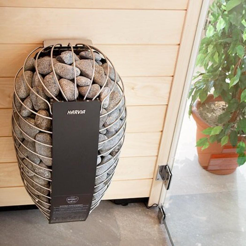 Harvia Spirit SP90E sauna heater installed in a modern sauna environment with stone heating elements and wooden interior.