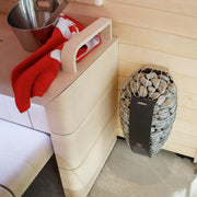 Harvia Spirit sauna heater wall-mounted beside a light wood sauna bench