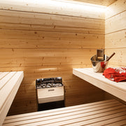 Harvia The Wall stainless steel sauna heater installed in a light spruce sauna