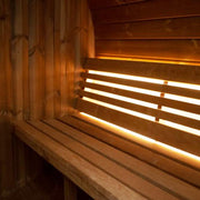 Close-up of LED-lit bench inside SaunaLife Model E6 outdoor barrel sauna showing wooden seating and cozy interior details.