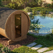 SaunaLife E6 barrel sauna beside a natural garden pond