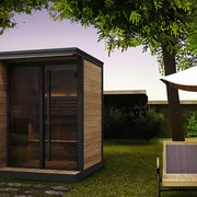SaunaLife GL4 outdoor sauna beside a patio lounge area under a tree