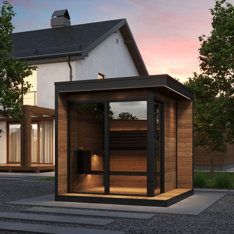 SaunaLife GL6 outdoor sauna with panoramic glass front installed in a backyard at sunset