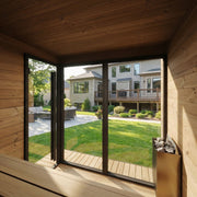 View from inside the SaunaLife GL6 outdoor sauna through the glass front to the backyard