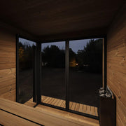 Interior view of SaunaLife GL6 outdoor sauna kit showing wooden benches and interior lighting in a spacious sauna cabin.