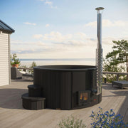 SaunaLife Model S4B wood burning hot tub with wooden exterior and open seating area, set outdoors in a natural environment