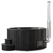 SaunaLife Model S6B wood burning hot tub with wooden exterior and seating, set outdoors with surrounding greenery.