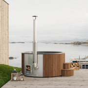 SaunaLife Model S6N wood-burning hot tub filled with water, featuring wooden exterior and seating area for outdoor relaxation.