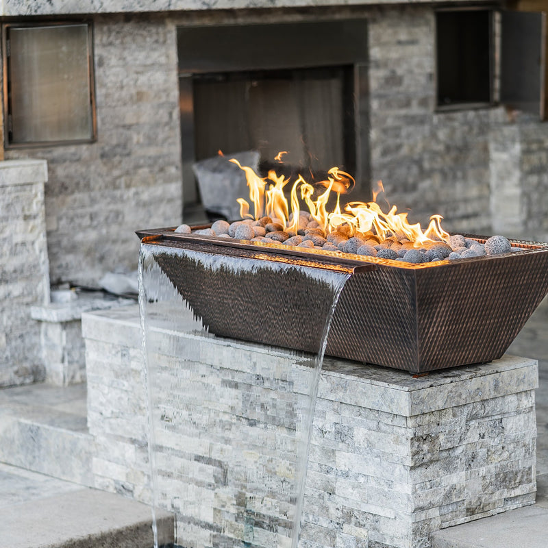 Maya hammered copper fire and water bowl installed on a stone pillar