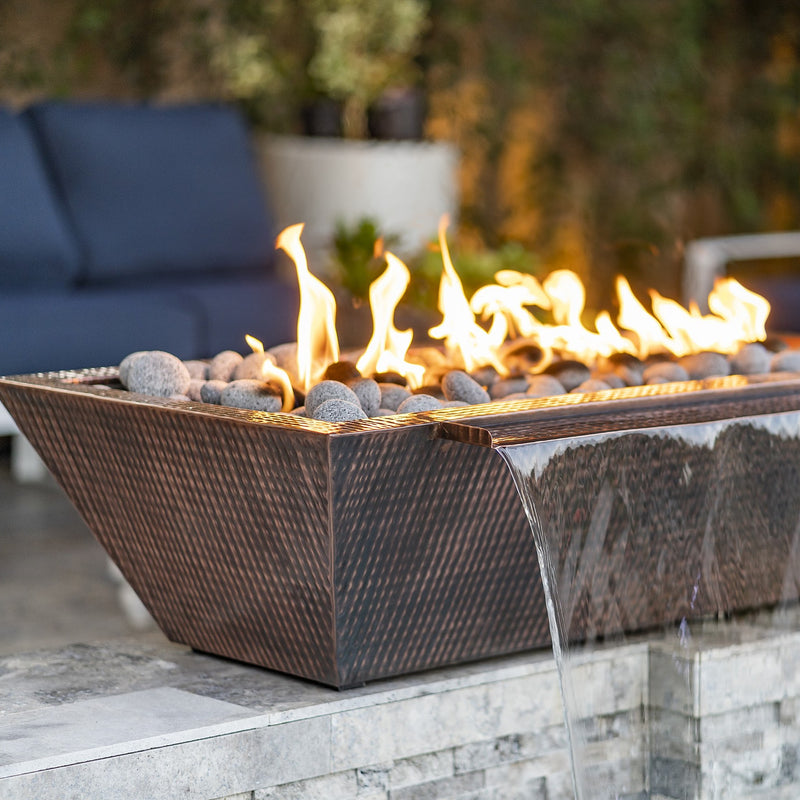 Maya copper fire and water bowl with water spill on a patio